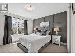 Spacious primary bedroom featuring great natural light, a walk-in closet, and a beautifully appointed ensuite with dual vanities and a tile shower. - 