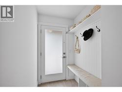 Welcoming front foyer with a built-in bench and dedicated storage space for coats, shoes, and everyday essentials. - 
