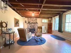 Downstairs Living Area w/ classic stone fireplace - 