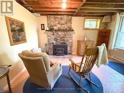 Downstairs Living Area w/ classic stone fireplace - 