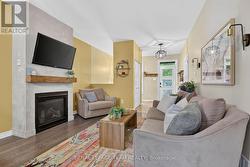 Cozy gas fireplace finished floor to ceiling. - 