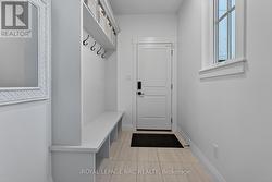 Mudroom with built-ins leads to garage and outside - 
