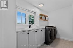 Upstairs laundry room with custom cabinetry. - 