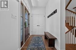 Good sized entry with closet and bench. - 
