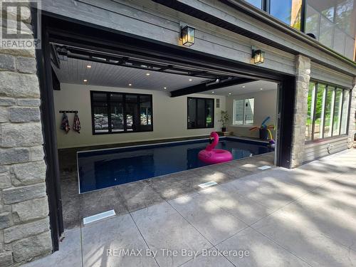 Indoor/Outdoor Pool Area with Doors Open - 95 Spruce Street, Tiny, ON 