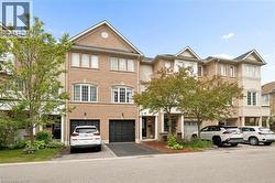 Multi-level townhome featuring a brick facade and multiple bay windows - 