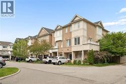 End-unit townhome featuring a brick exterior and multiple bay windows - 