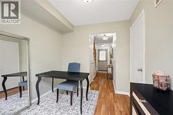 Light-toned walls complement wood-finish flooring throughout this interior space - 