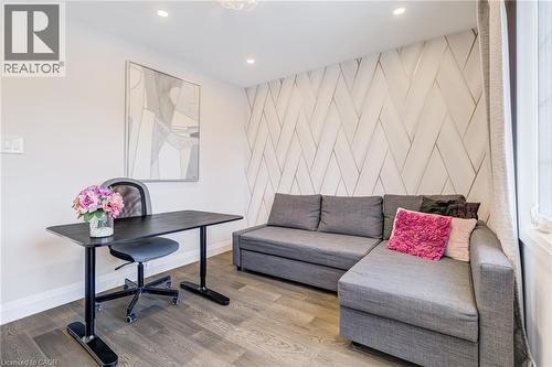 Accent wall with geometric paneling, recessed ceiling lighting, and wood-finish flooring - 1320 Monmouth Drive, Burlington, ON 