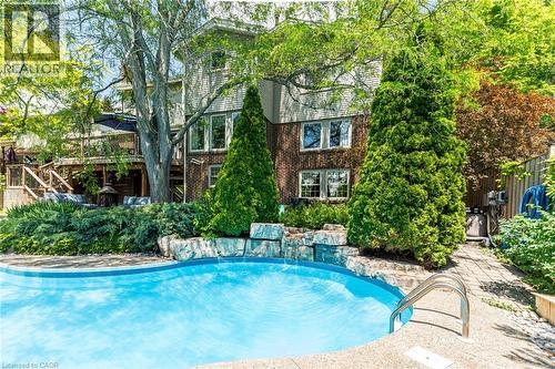 Curved inground pool with concrete surround - 1320 Monmouth Drive, Burlington, ON 