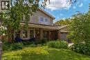 Two-story residence featuring brick and siding facade, covered front porch, and an attached two-car garage - 1320 Monmouth Drive, Burlington, ON 