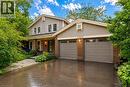 Two-story residence featuring a brick and siding exterior, an attached two-car garage with transom windows, and a covered front entry - 1320 Monmouth Drive, Burlington, ON  - Outdoor With Deck Patio Veranda 