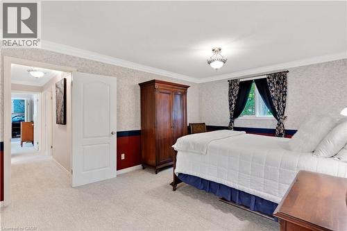 Bedroom featuring textured wallpaper with a two-tone accent band, plush carpet flooring, and a window with trim - 110 Grand Ridge Drive, Cambridge, ON 