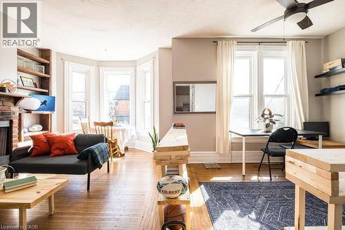Second floor unit drenched in sunshine, offering versatile living space and a decorative fireplace that adds charm and character. - 270 Queen Street S, Hamilton, ON 
