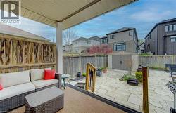 Covered patio with a paneled ceiling and support columns - 