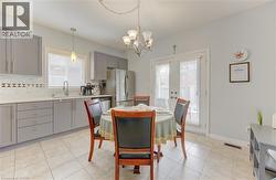 Kitchen with light gray cabinetry, white countertops, and a tiled backsplash - 