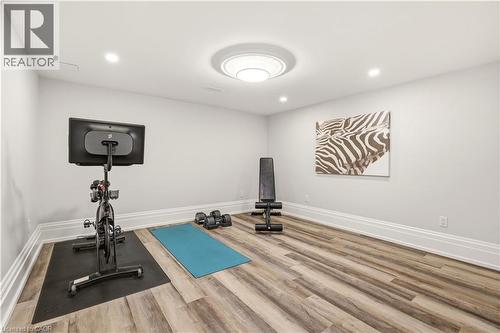Recessed lighting illuminating a spacious room with wood-finish flooring - 336 Newbold Court, Burlington, ON 