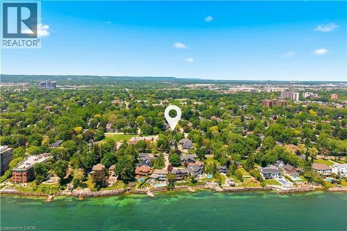 Expansive waterfront setting featuring a prominent shoreline, lush tree canopy, and residential properties - 336 Newbold Court, Burlington, ON 
