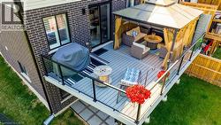 Expansive elevated deck featuring composite decking and a glass railing system - 