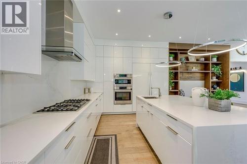 Modern kitchen featuring white high-gloss cabinetry and a spacious center island - 2104 Devon Road, Oakville, ON - Indoor Photo Showing Kitchen With Upgraded Kitchen