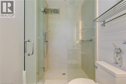 Glass-enclosed shower with a rainfall showerhead and handheld sprayer, featuring polished chrome fixtures - 2104 Devon Road, Oakville, ON - Indoor Photo Showing Bathroom