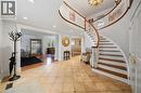 Grand foyer featuring a curved staircase with wood treads and a white balustrade - 39 Elodia Court, Hamilton, ON 