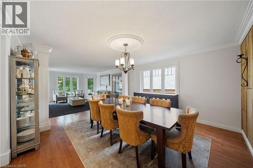 Dining area featuring wood-finish flooring, crown molding, and a chandelier with a decorative ceiling medallion - 39 Elodia Court, Hamilton, ON 