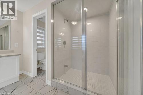 Full bathroom featuring a stall shower, vanity, and light marble finish floors - 285 Broadacre Drive, Kitchener, ON 