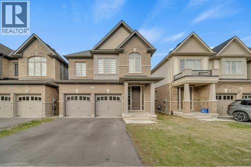 View of front of property with brick siding, driveway, a garage, and a front yard - 285 Broadacre Drive, Kitchener, ON 
