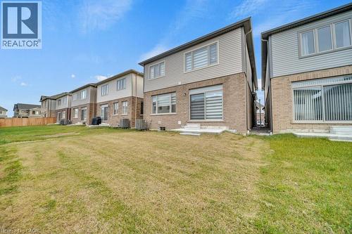 Rear view of property with a yard, brick siding, and a residential view - 285 Broadacre Drive, Kitchener, ON 