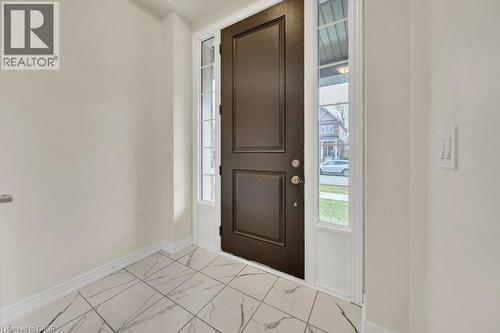 Entryway with light marble finish flooring and plenty of natural light - 285 Broadacre Drive, Kitchener, ON 