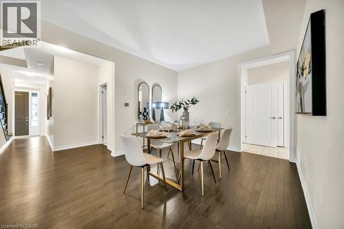 Dining room featuring dark wood-type flooring and stairs - 285 Broadacre Drive, Kitchener, ON 