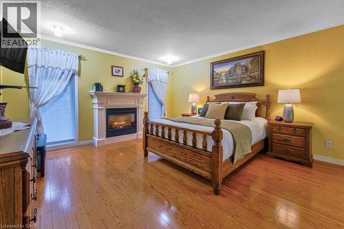 principal bedroom with gas fireplace - 247 Rolling Acres Court, Kitchener, ON - Indoor Photo Showing Bedroom