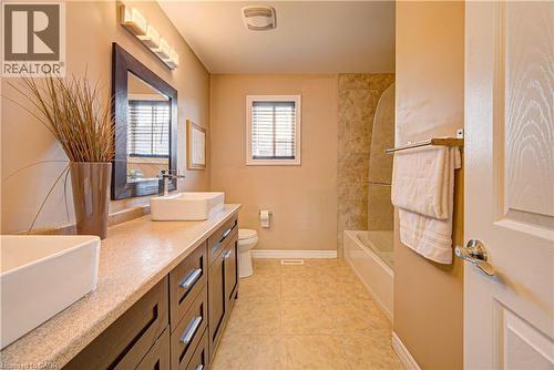 Bathroom featuring a dual-sink vanity with rectangular vessel sinks, dark wood cabinetry, and a light speckled countertop - 37 Davinci Boulevard, Hamilton, ON 
