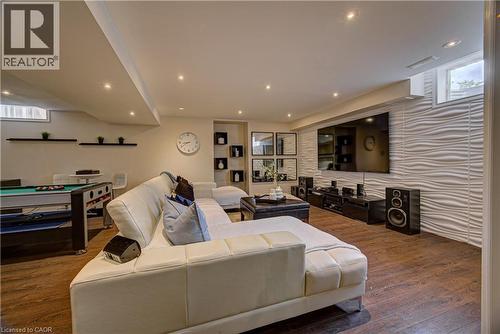 Entertainment area featuring wood-finish flooring and recessed lighting - 37 Davinci Boulevard, Hamilton, ON 