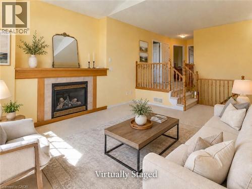 Living space featuring a fireplace with a wood mantle and tile surround - 212 Sleaford Street, Waterloo, ON 