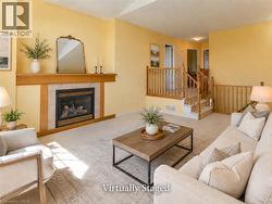 Living space featuring a fireplace with a wood mantle and tile surround - 