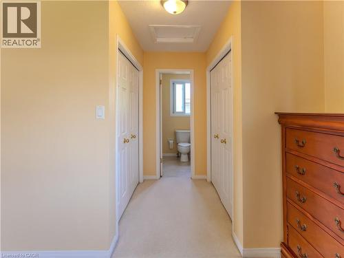 Hallway featuring light-toned carpeting and neutral wall paint - 212 Sleaford Street, Waterloo, ON 
