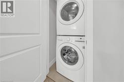 Stackable washer and dryer unit, featuring white finish and front-loading design - 