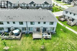 Rear exterior featuring individual wooden decks and stone facade accents - 