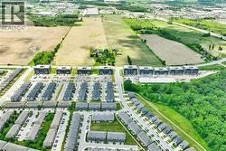 Aerial perspective showcasing a developing residential area with modern townhomes and multi-story apartment buildings - 