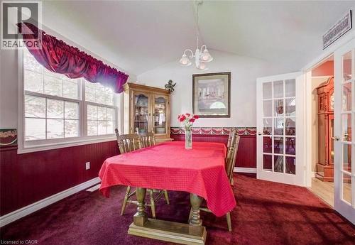 Dining area featuring vaulted ceilings and a multi-pane window - 599 Coldstream Drive, Waterloo, ON 
