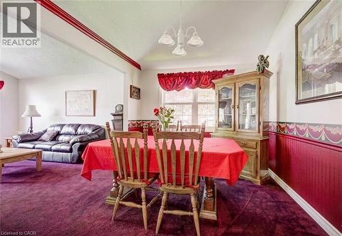 Dining area featuring rich purple carpeting and white walls - 599 Coldstream Drive, Waterloo, ON 