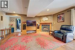 Spacious living area featuring wood-finish flooring and recessed lighting - 
