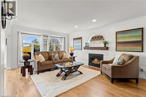 Hardwood-finish flooring complements white shiplap walls - 26 Shadyridge Place, Kitchener, ON 