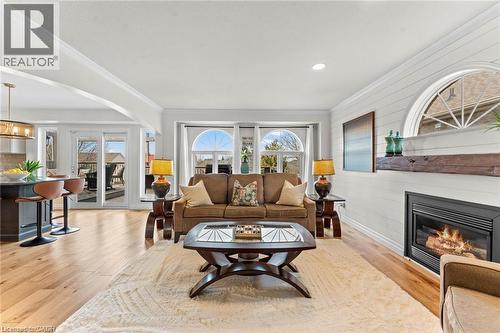 Living area featuring light wood-finish flooring and a white shiplap accent wall - 26 Shadyridge Place, Kitchener, ON 