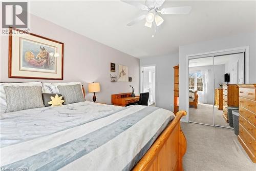 Bedroom featuring light-toned walls, a ceiling fan with integrated lighting, and carpet flooring - 26 Shadyridge Place, Kitchener, ON 