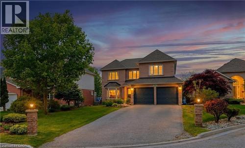 Brick-clad residence featuring a two-car garage, bay window, and a paved driveway - 26 Shadyridge Place, Kitchener, ON 