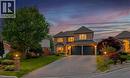 Brick-clad residence featuring a two-car garage, bay window, and a paved driveway - 26 Shadyridge Place, Kitchener, ON 