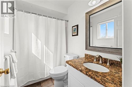 Bathroom featuring a white vanity with an oval undermount sink, a bronze-finish faucet, and a patterned stone countertop - 26 Shadyridge Place, Kitchener, ON 